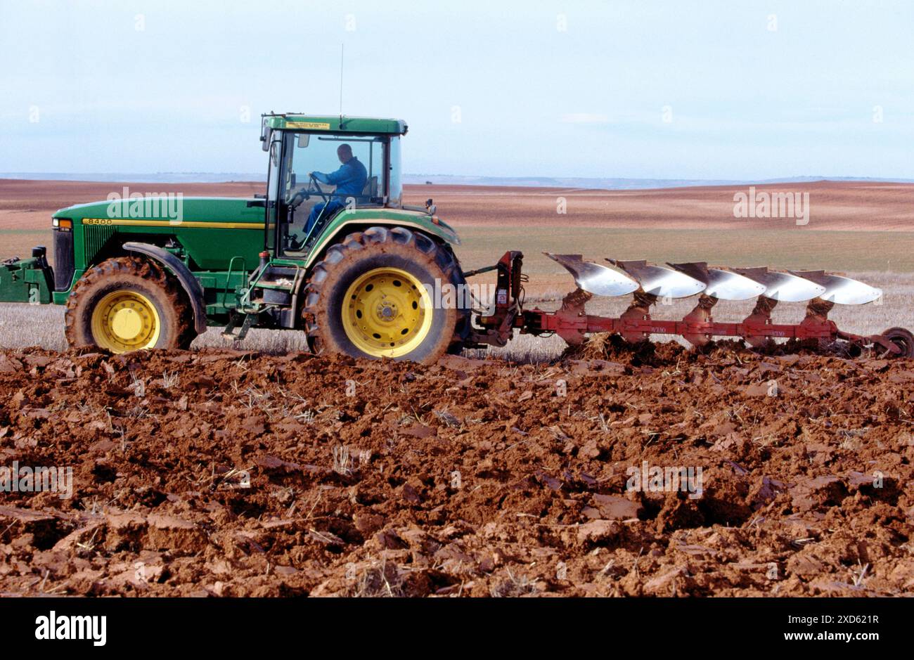 Tractor dragging a plough Stock Photo - Alamy
