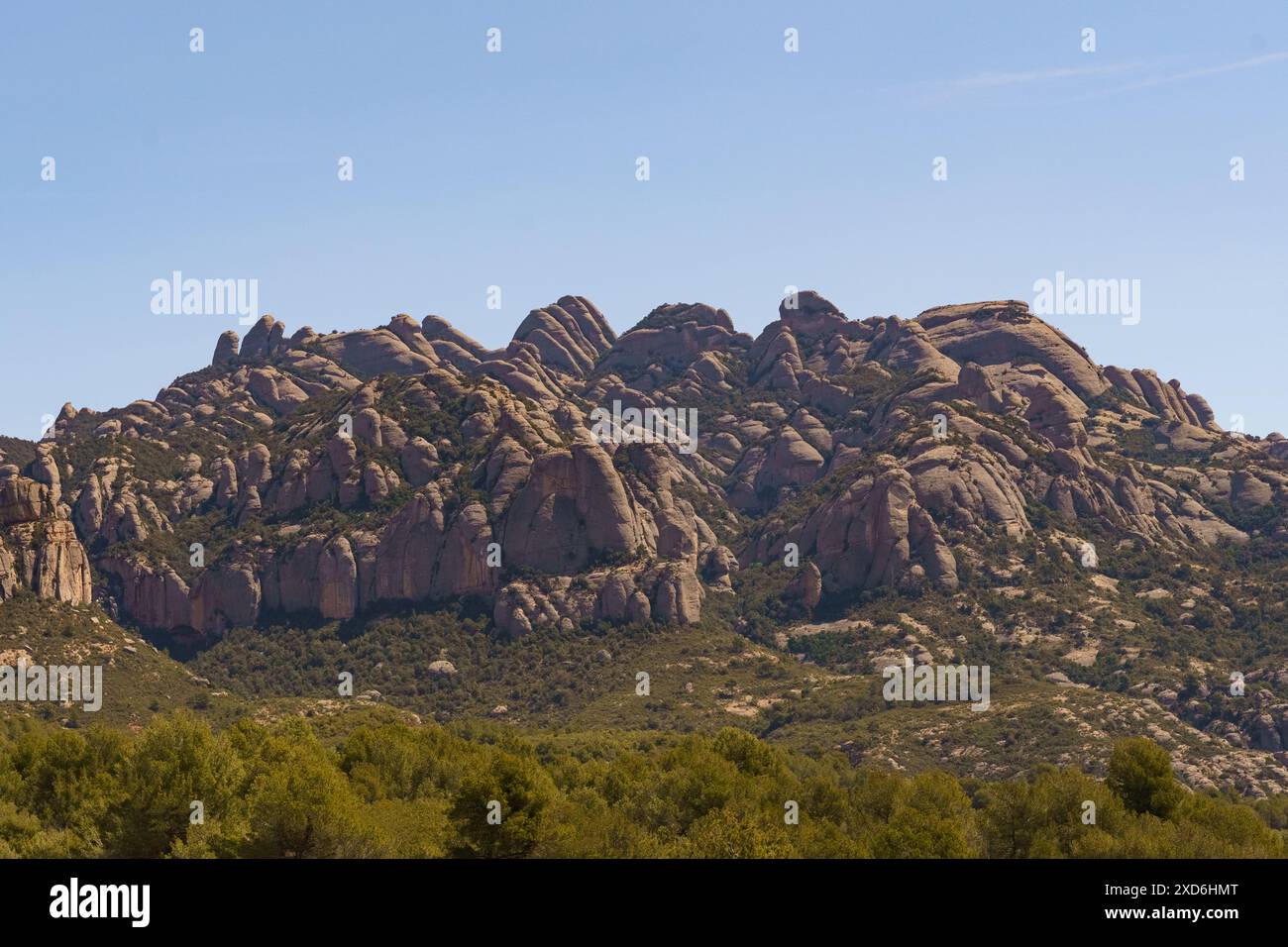 A view of the iconic Montserrat Mountains in Spain from a field in the ...