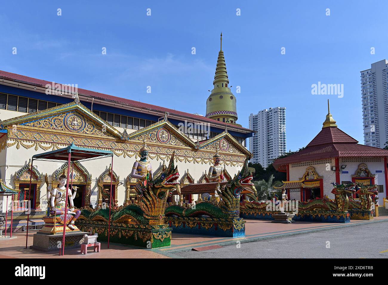 Ornate mythical naga serpents & Yaksha deities guarding entrance of main prayer hall of Wat Chayamangkalaram, oldest Siamese Buddhist temple in Penang Stock Photo