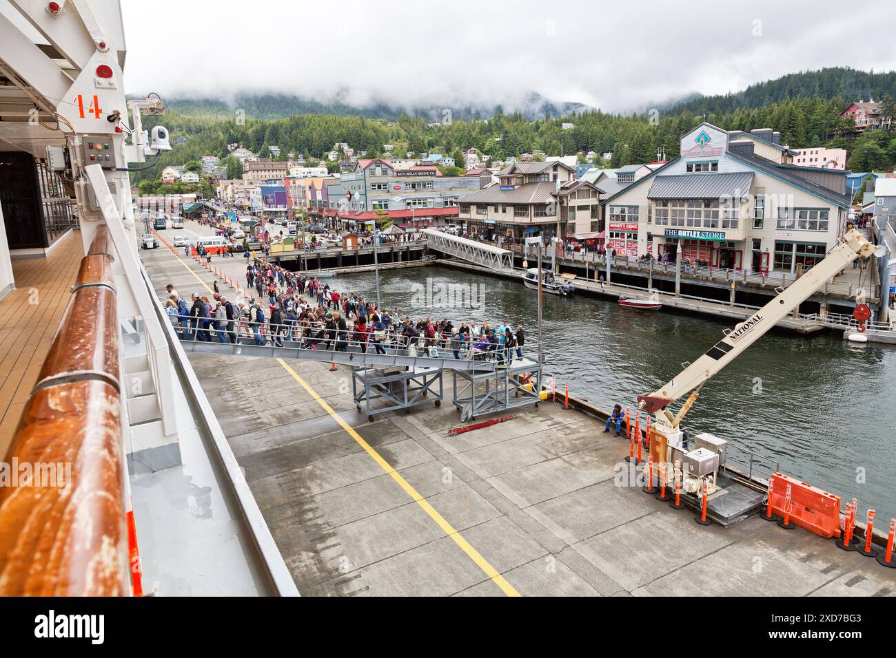 Port Of Ketchikan, passengers returning from shopping & shore excursions to Carnival Panorama Luminosa Cruise Ship, intruding fog,  Alaska. Stock Photo