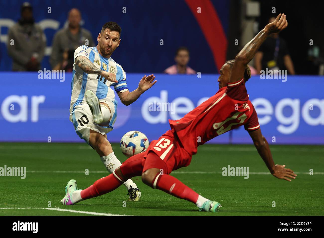 Argentina's forward Lionel Messi (L) vies for the ball with Canada’s