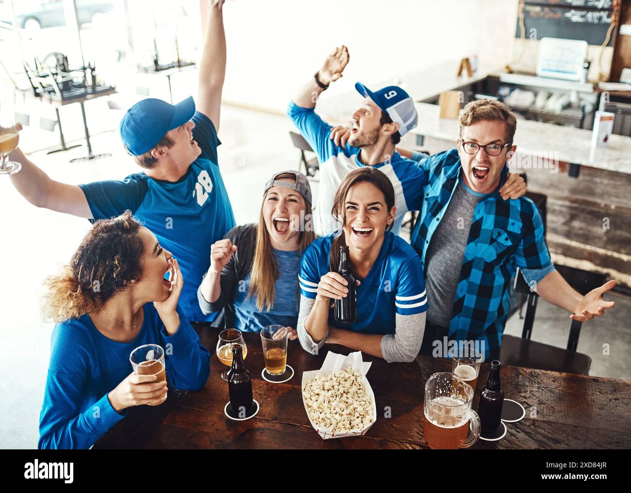 Sports, celebrate and group of people in pub with high five 