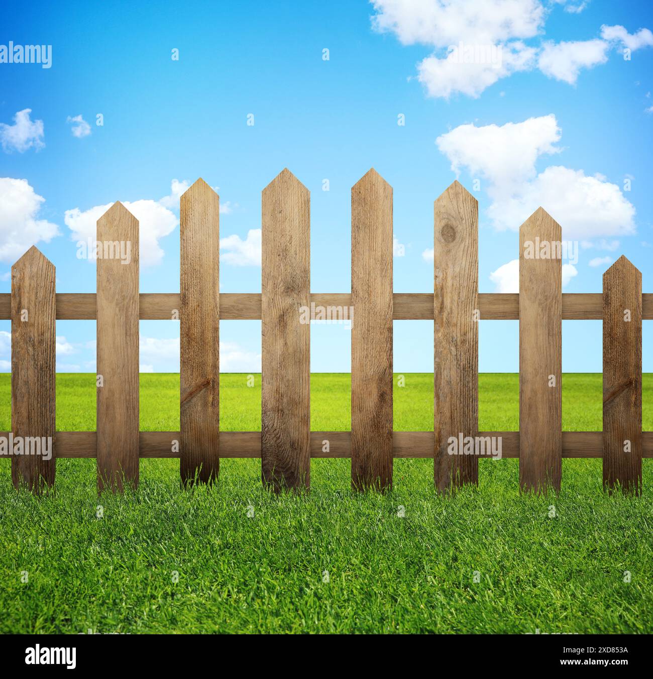 Wooden fence and green grass under blue sky with clouds outdoors Stock ...