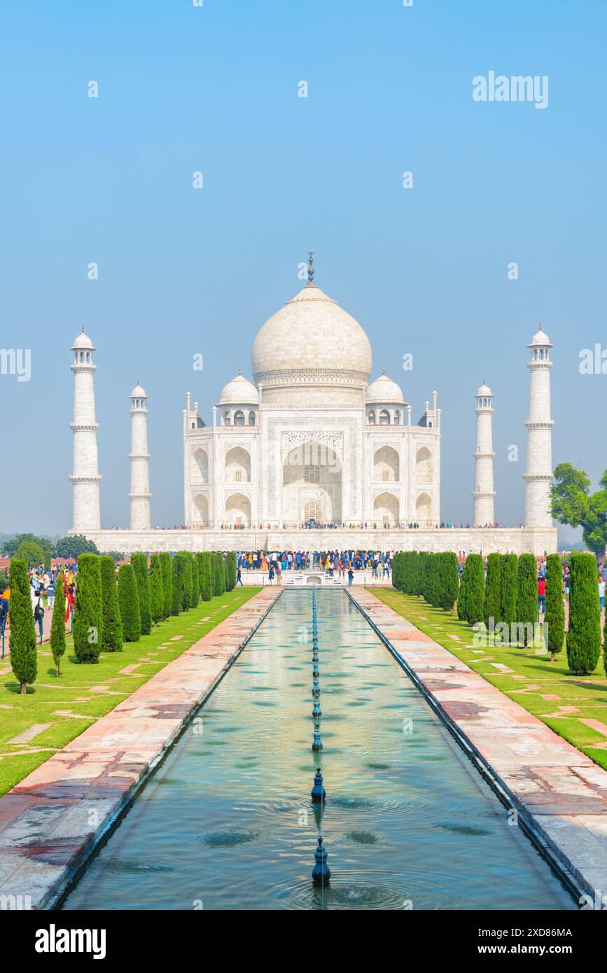 Colorful crowds of visitors walking along the Taj Mahal complex in Agra ...