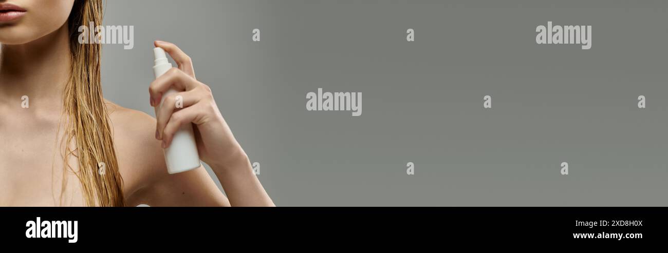 A young beautiful woman demonstrating a hair care routine Stock Photo ...