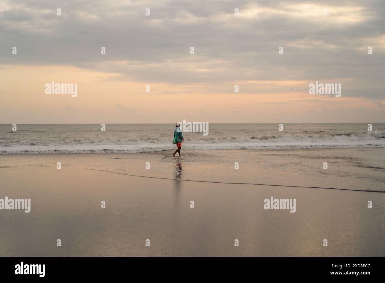 Fisherman on the ocean at sunset, Bali, Canggu. Stock Photo