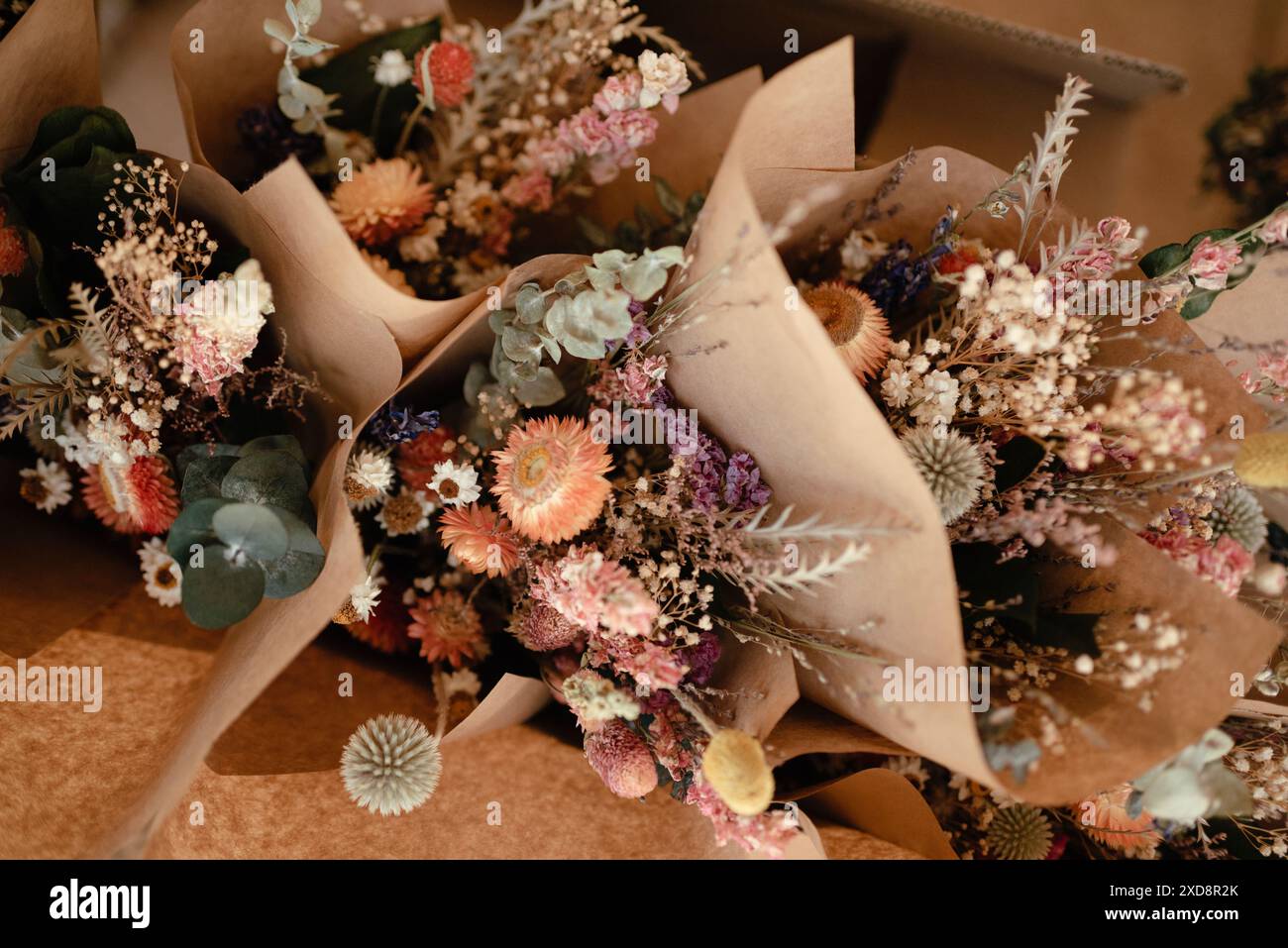 multiple boho dried floral arrangements in paper Stock Photo Alamy