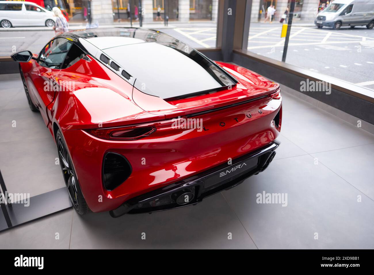 rear view new red Lotus Emira in showroom, British exciting sports car ...