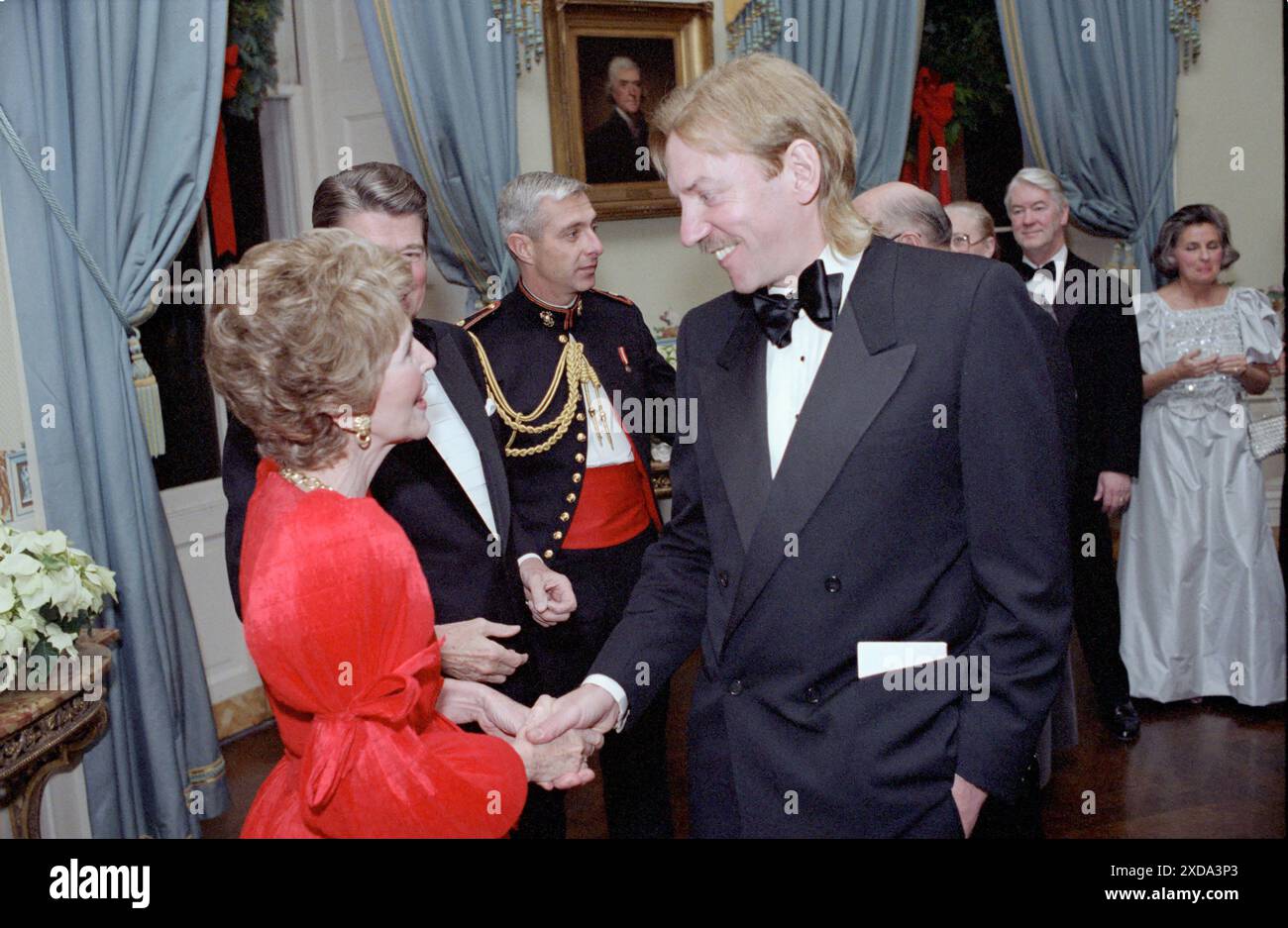 President Ronald Reagan and Nancy Reagan greet actor Donald Sutherland at the Kennedy Center Honors Reception in White House Blue Room, Washington, DC, 12/6/1981. Photo by White House Photo Collection. Stock Photo