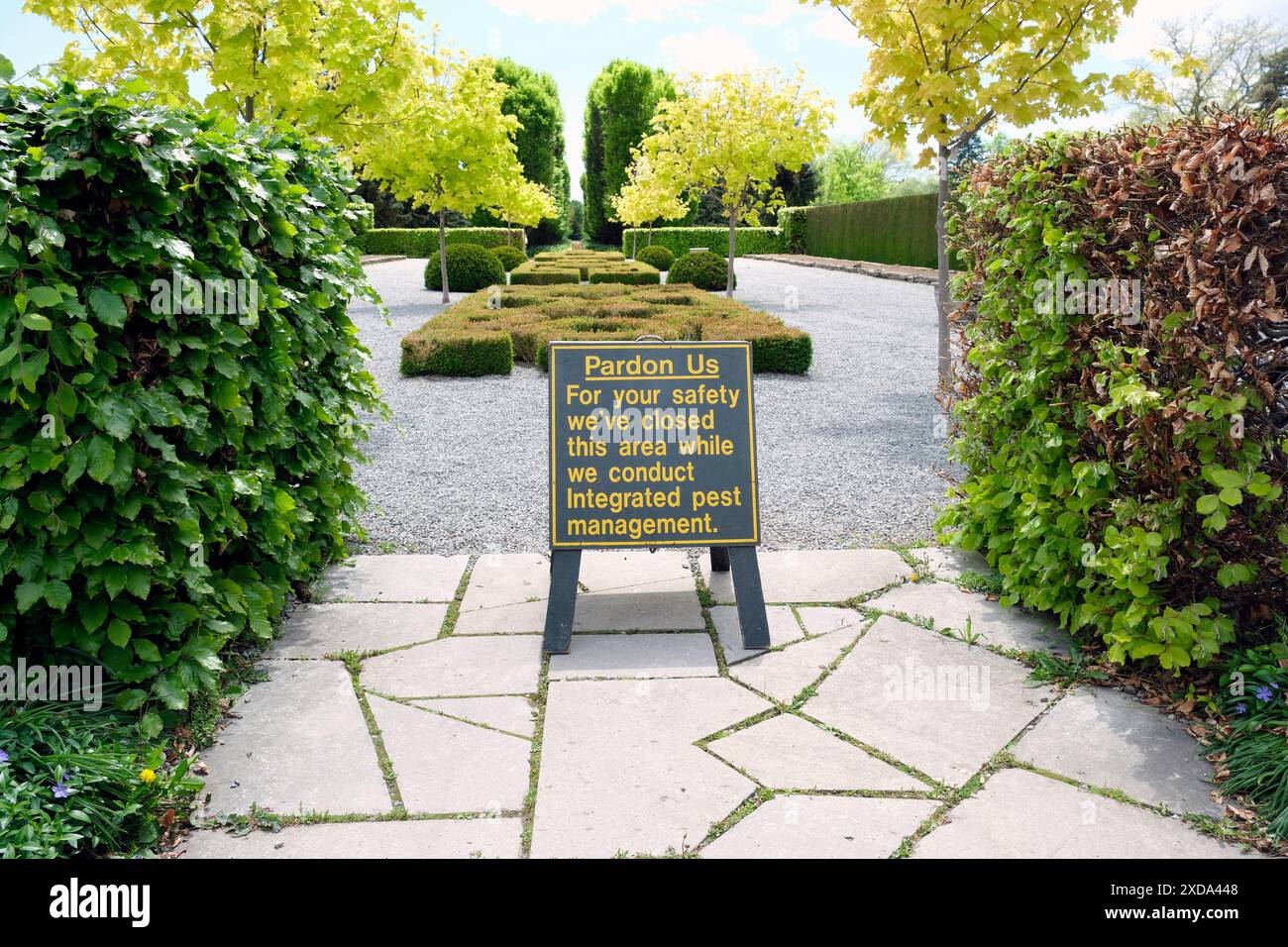Signage regarding integrated pest management in a public garden. Boxwood blight and box tree moth and its caterpillar has decimated these plants. Stock Photo