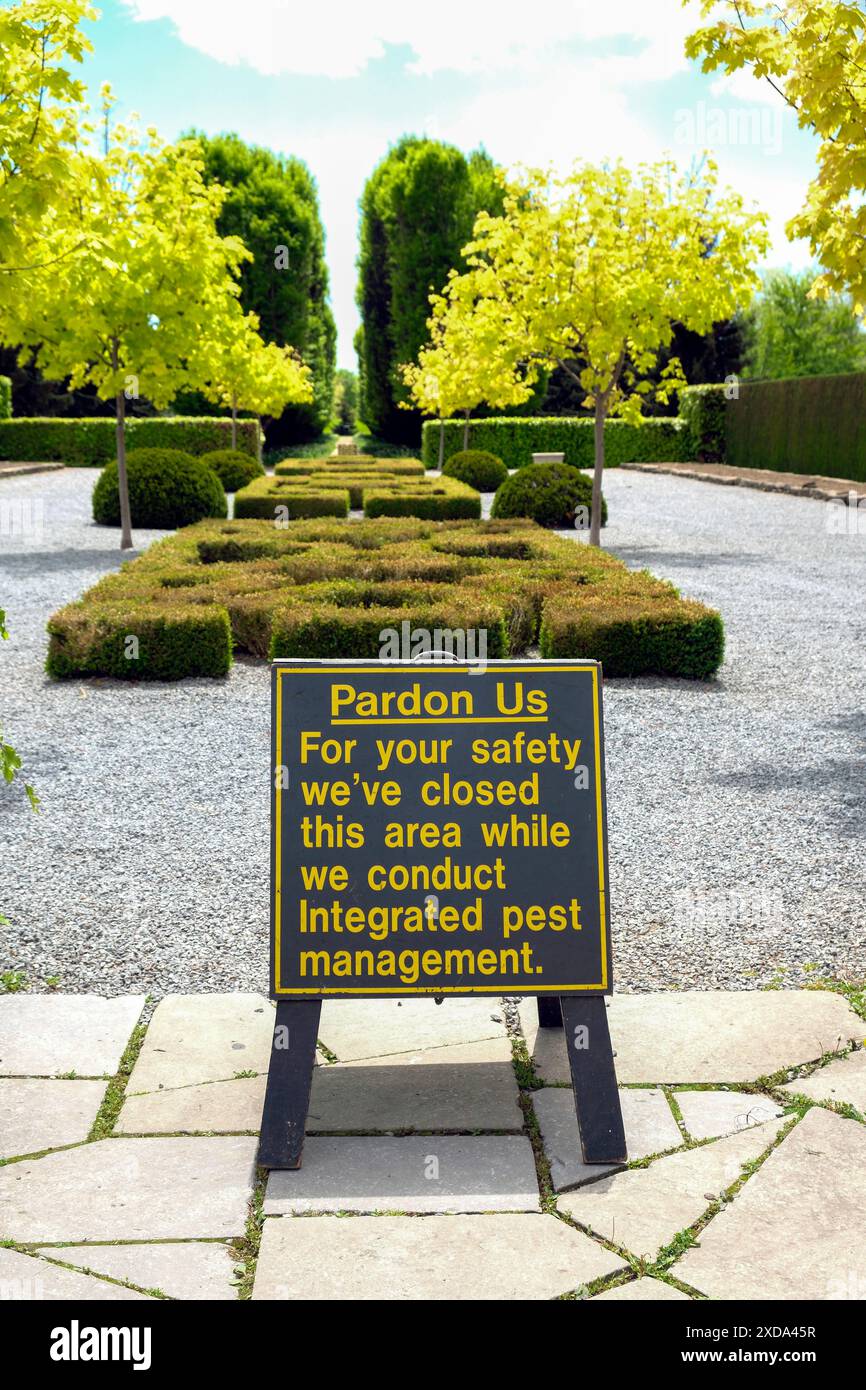Signage regarding integrated pest management in a public garden. Boxwood blight and box tree moth and its caterpillar has decimated these plants. Stock Photo