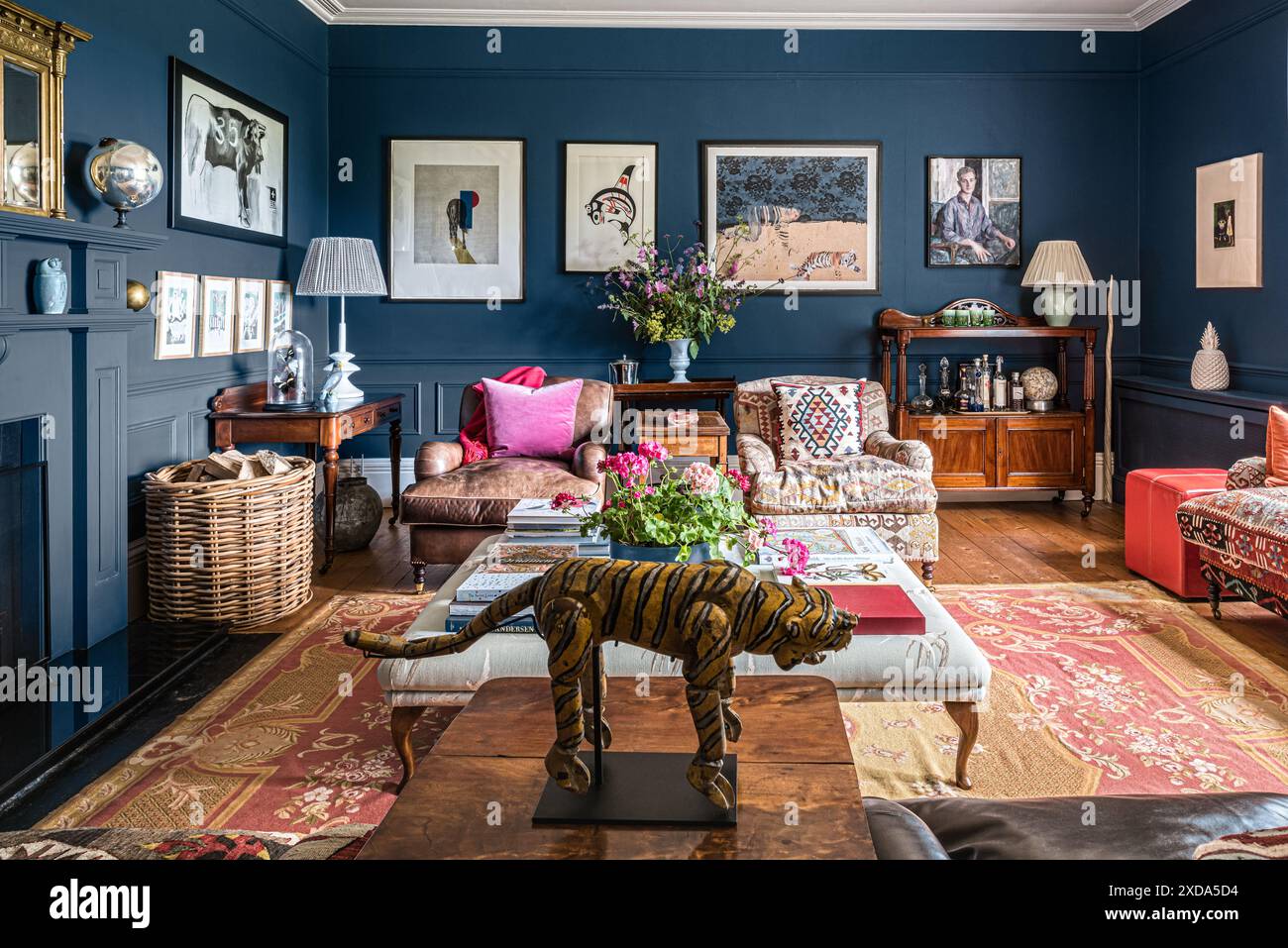 Dark Blue Walls Offset Prints And Collected Objects In Living Room Of dark-blue-walls-offset-prints-and-collected-objects-in-living-room-of