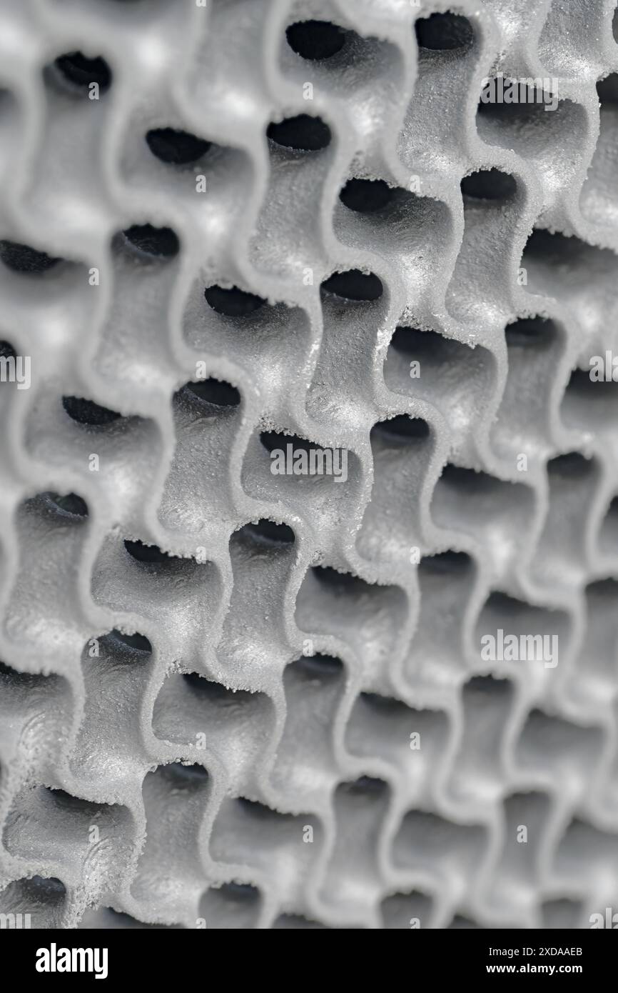 3D-printed metal wavy grid,  three-dimensional openwork lattice close up shot. Abstract modern technology background. Stock Photo
