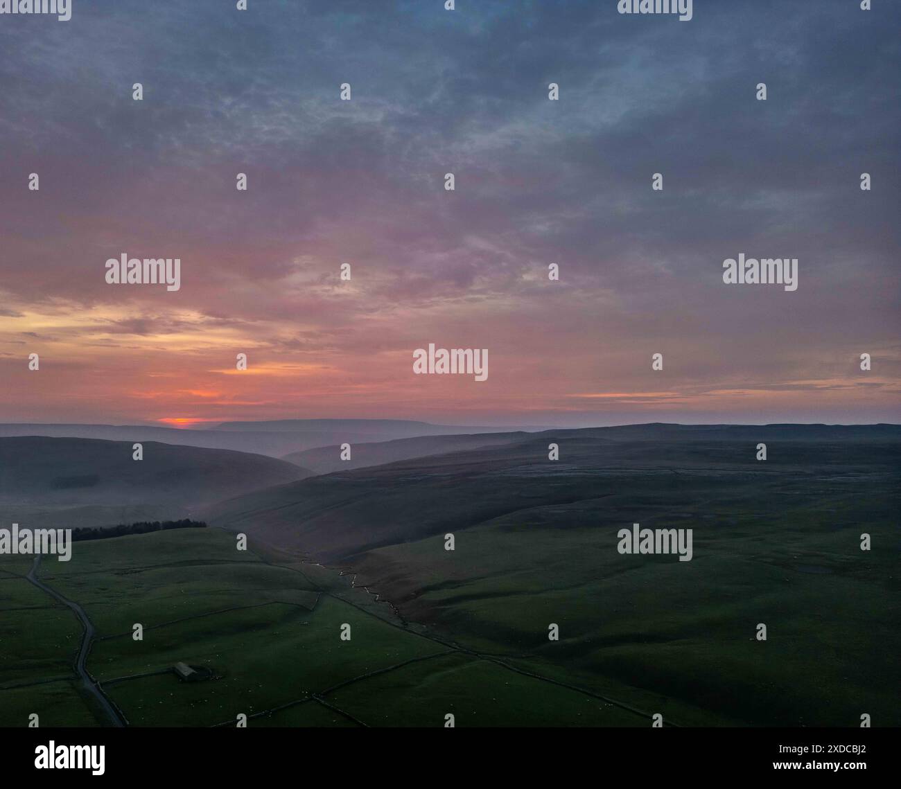 The vibrant colors of the sunset sky paint a dramatic backdrop over the ...