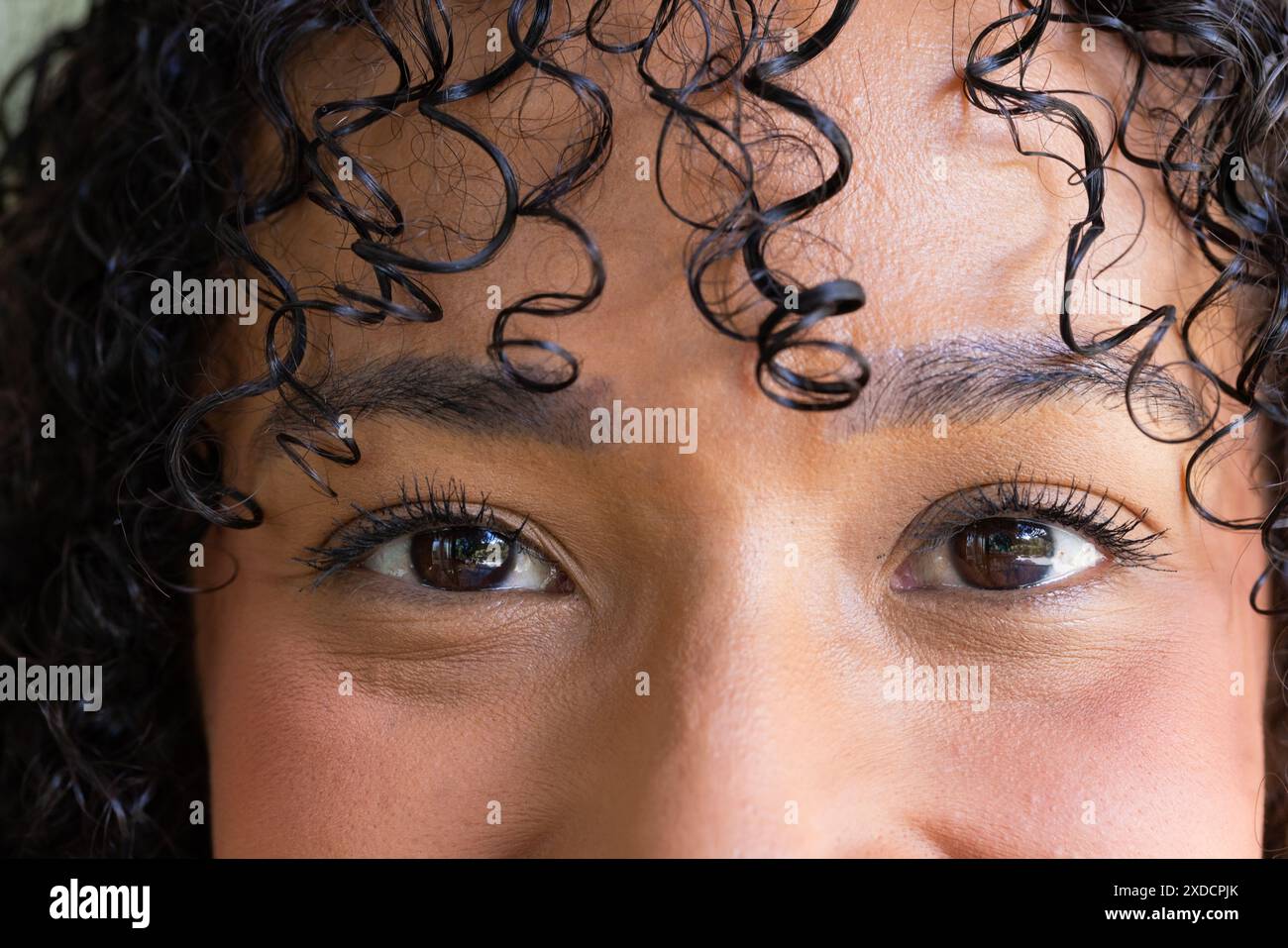 Close-up portrait of woman with curly hair and expressive eyes Stock ...