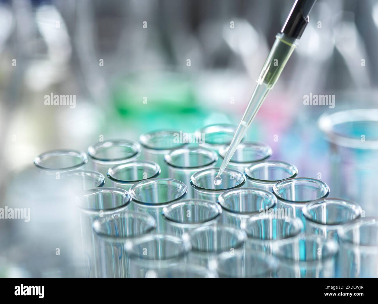 Scientist extracting samples using a pipette for analytical testing in the lab. Stock Photo