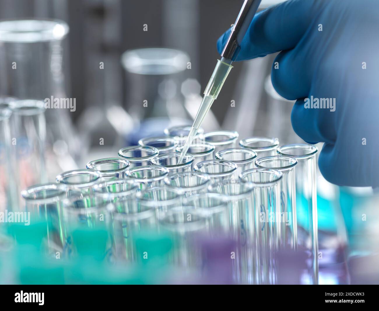 Scientist extracting samples using a pipette for analytical testing in the lab. Stock Photo