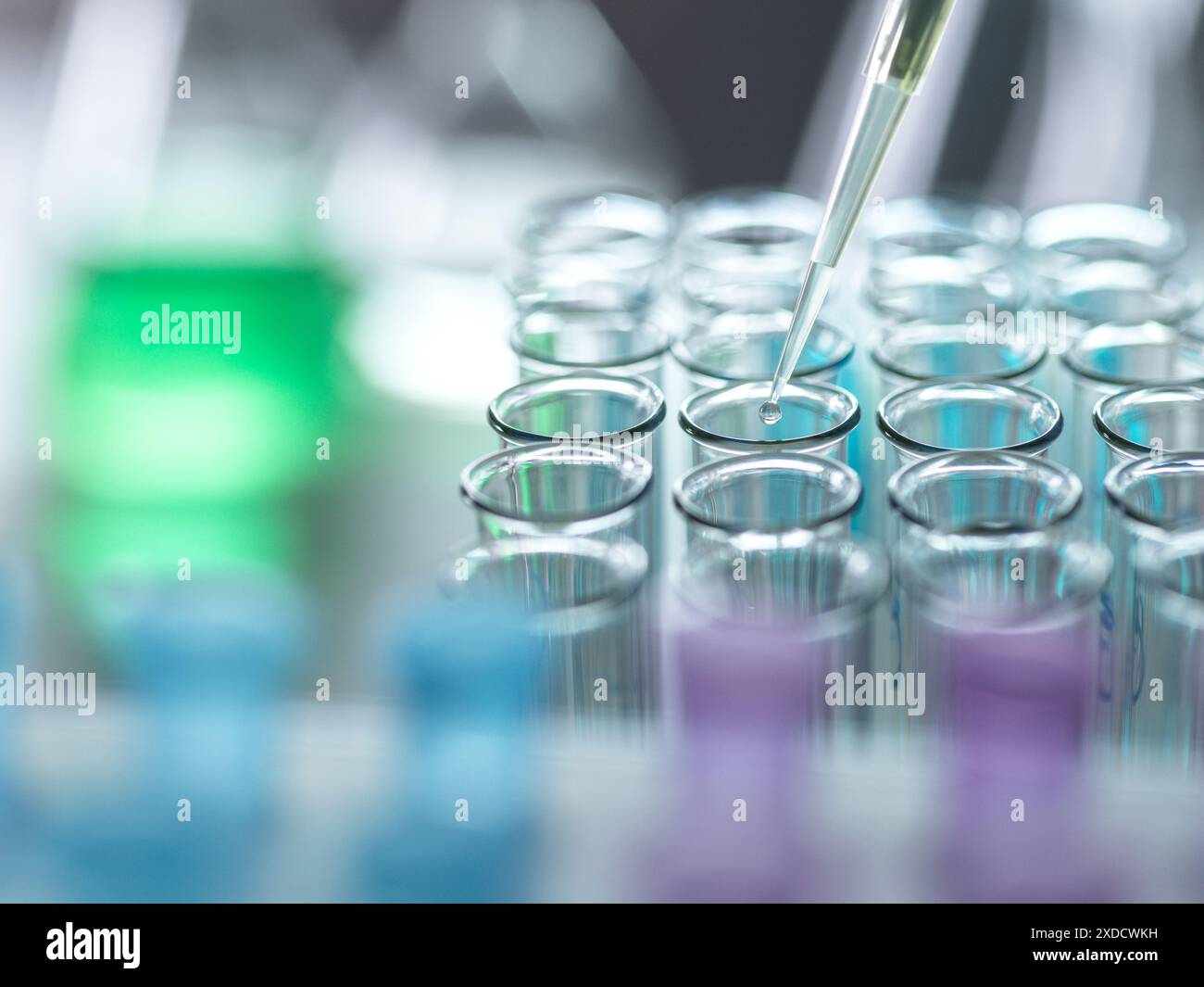 Scientist extracting samples using a pipette for analytical testing in the lab. Stock Photo
