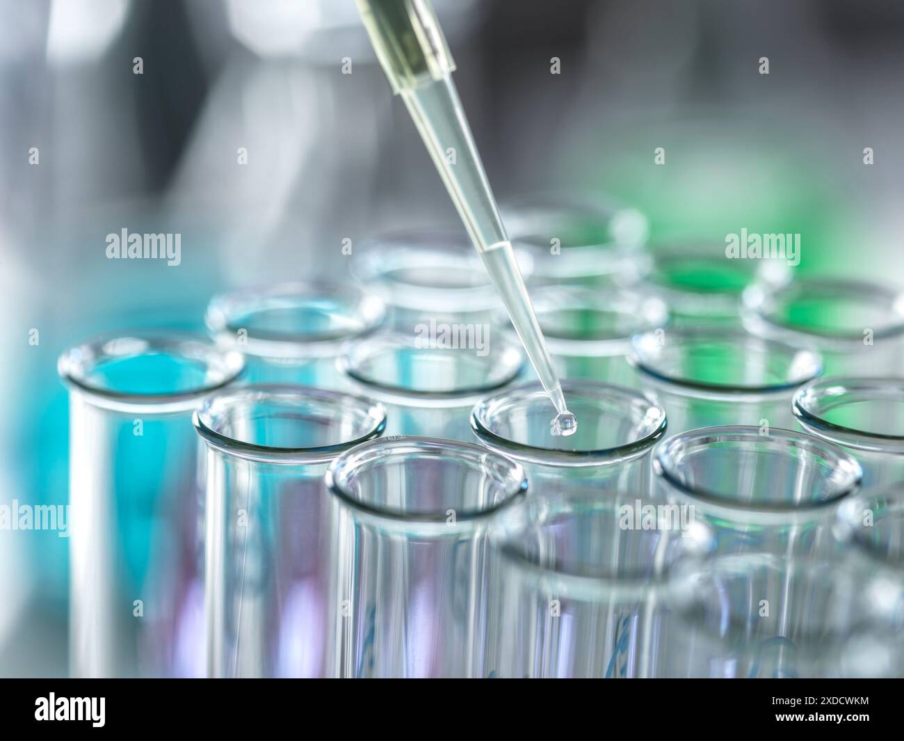 Scientist extracting samples using a pipette for analytical testing in the lab. Stock Photo