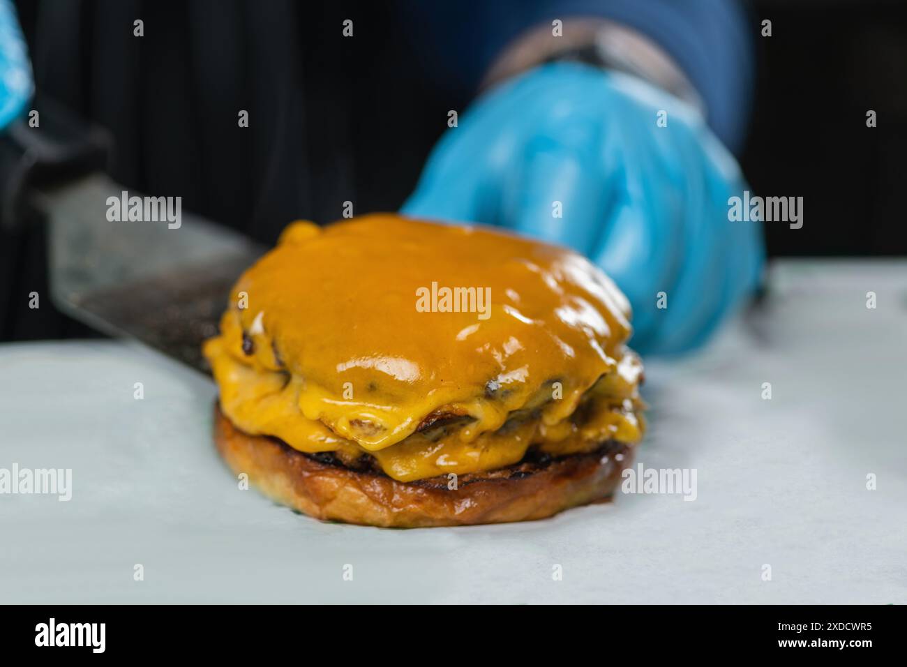 Cheeseburger without top bun. Stock Photo