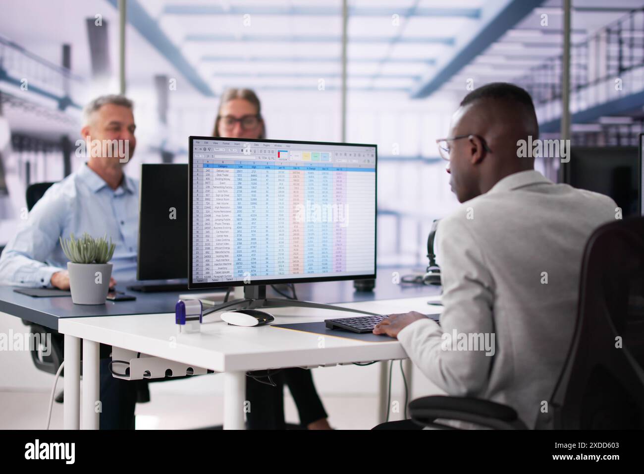 Data Analyst African Woman Using Spreadsheet On Computer Stock Photo