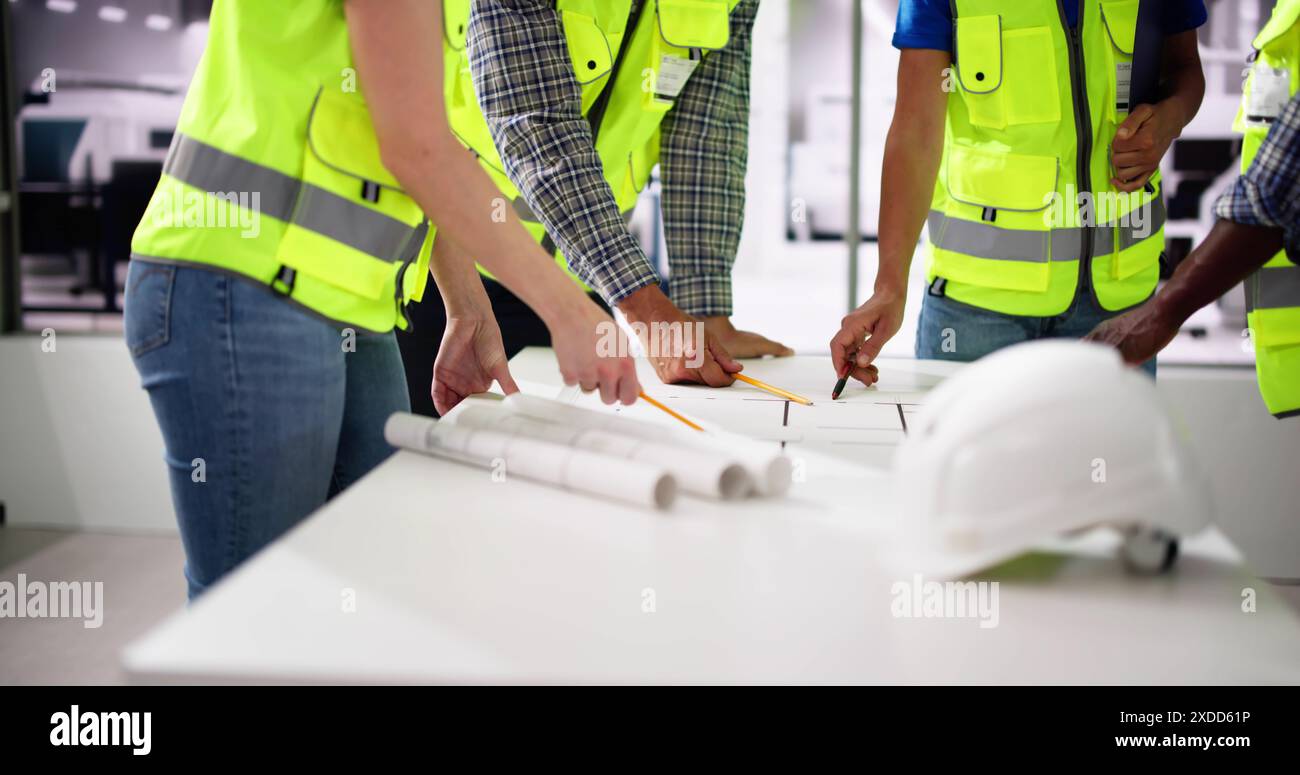 Civil Engineer Or Architect Team With Construction Plans Stock Photo