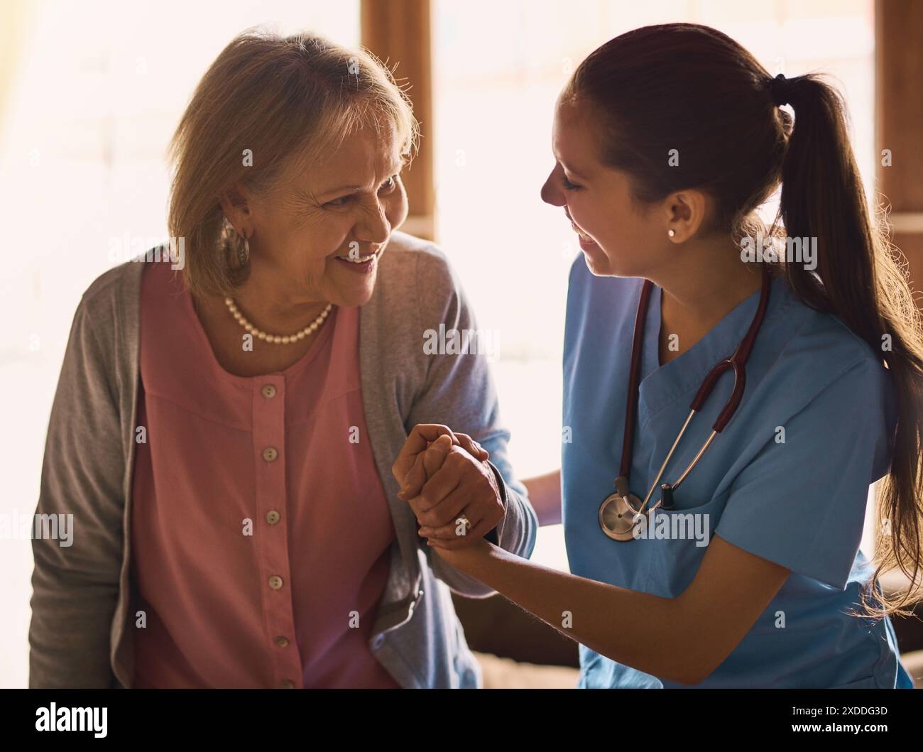 Nurse, senior woman and holding hands with compassion, comfort or ...