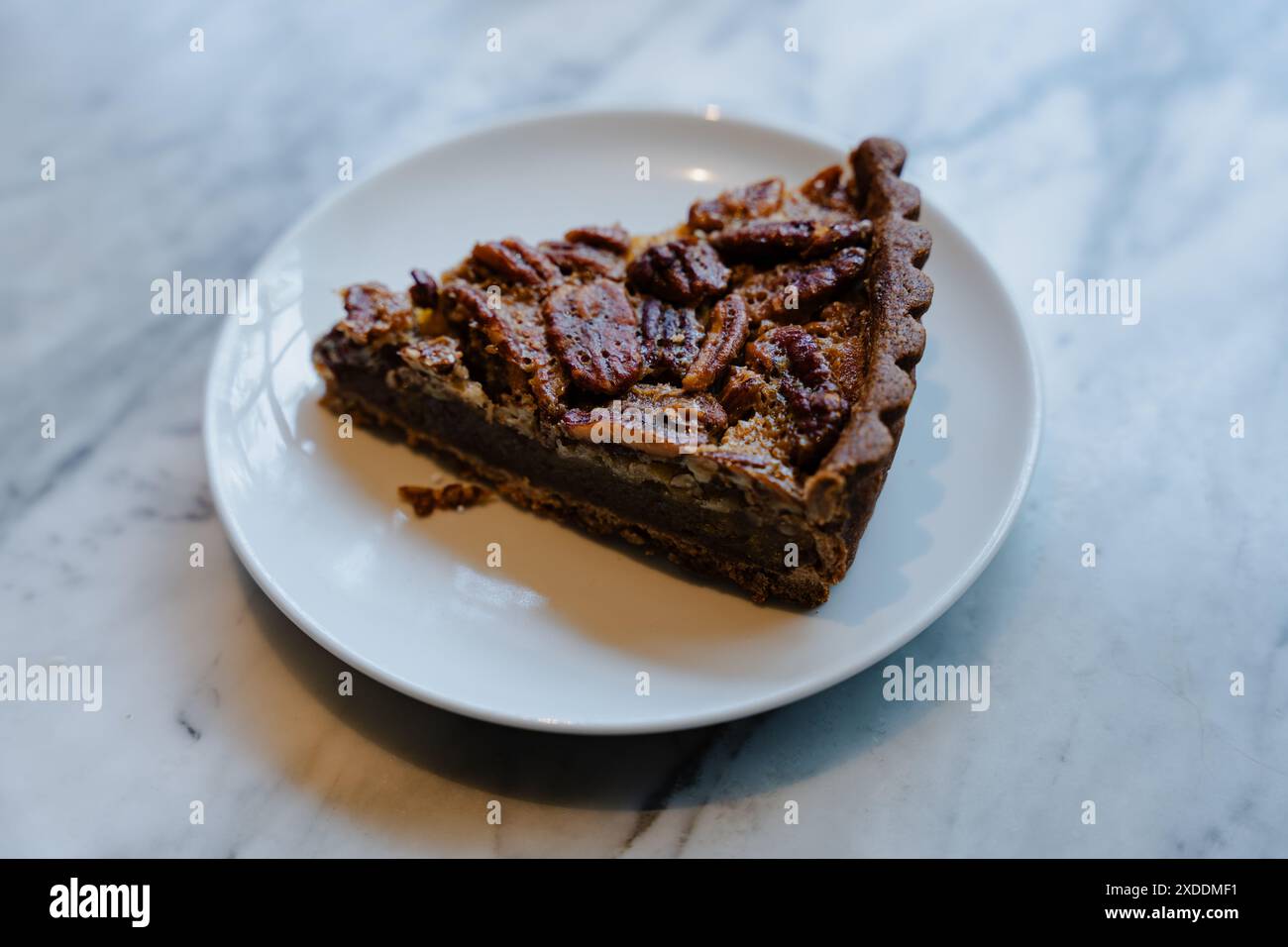 Slice of Pecan Pie on White Plate Stock Photo