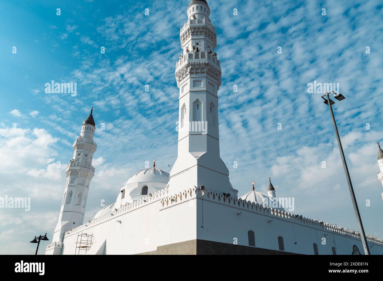 Medina, Saudi Arabia - December 22, 2022: The Quba Mosque stands against a blue sky with scattered clouds. Stock Photo