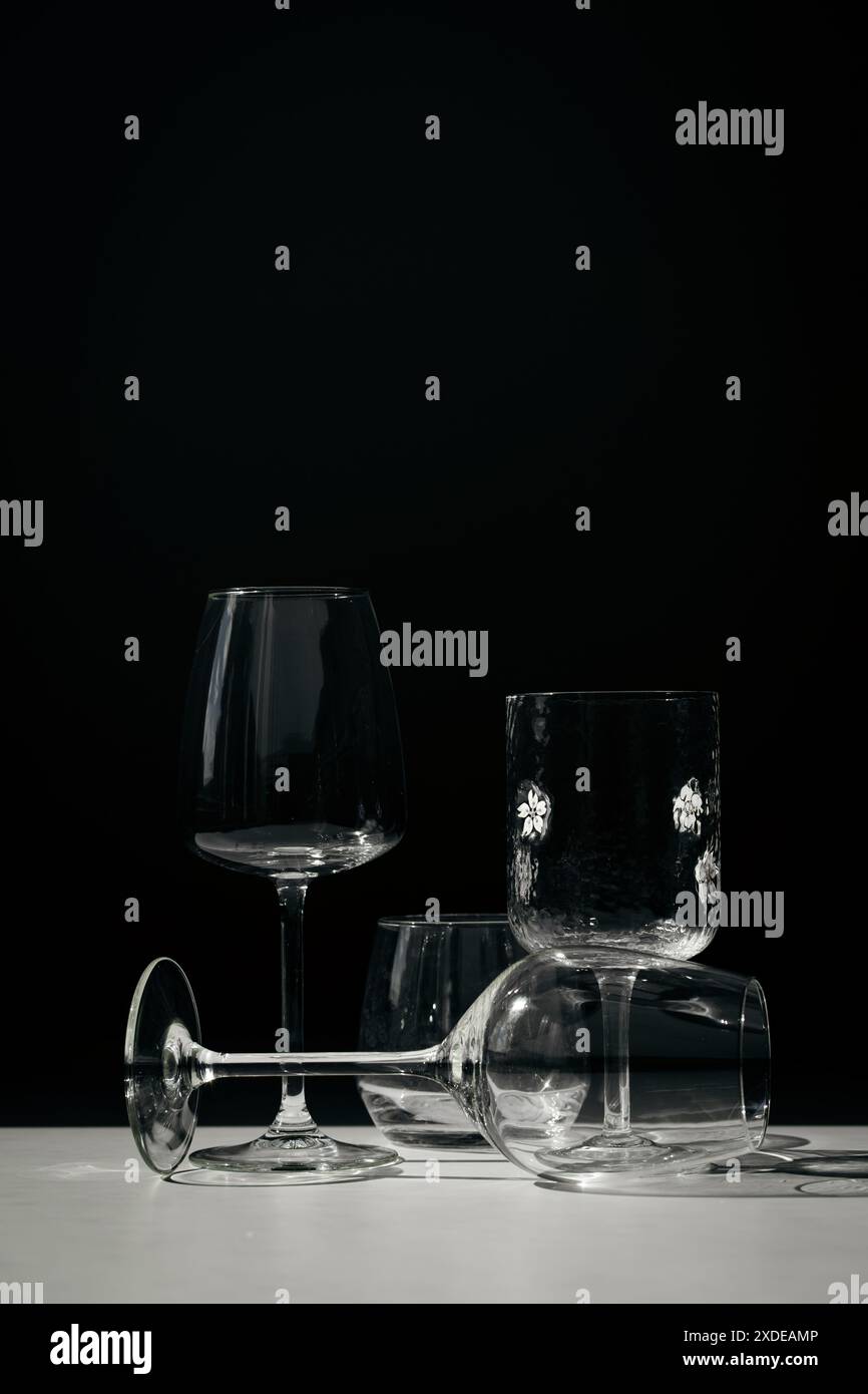 Assorted glassware for various drinks in sunlight. Stock Photo