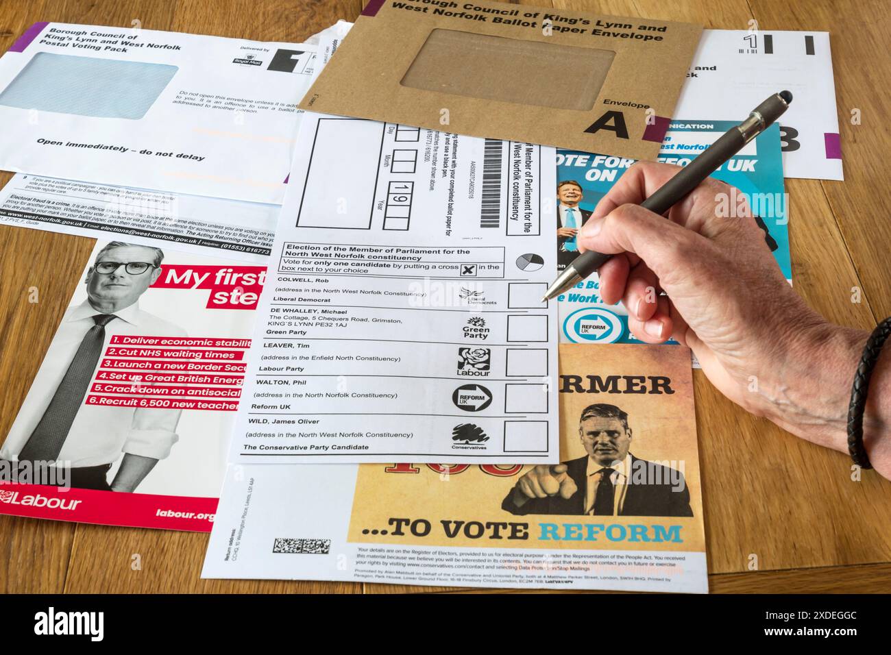 Woman completing a postal vote for the UK General Election 2024 with