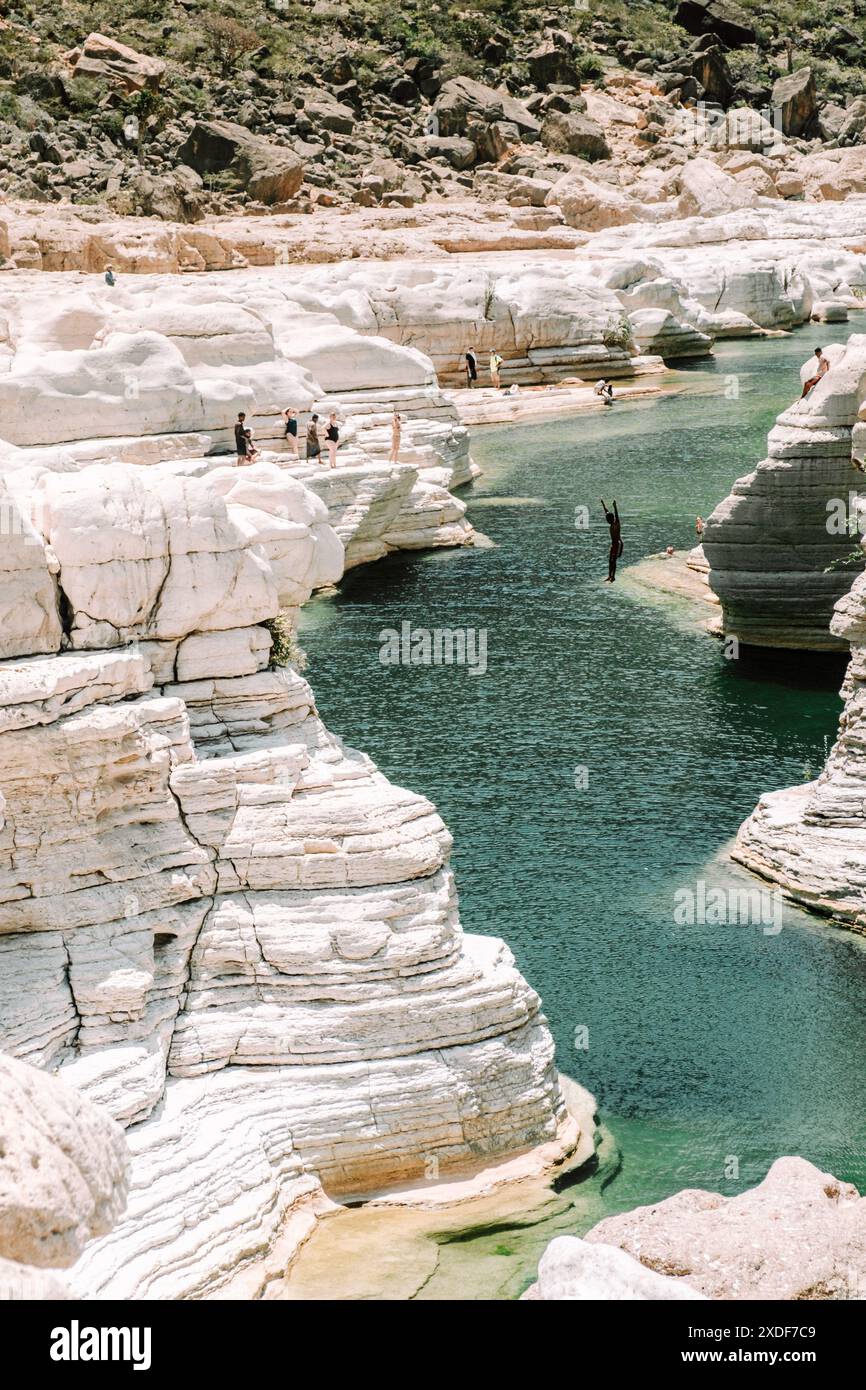 People jumping in Wadi Dirhur Canyon, Socotra Island, Yemen Stock Photo