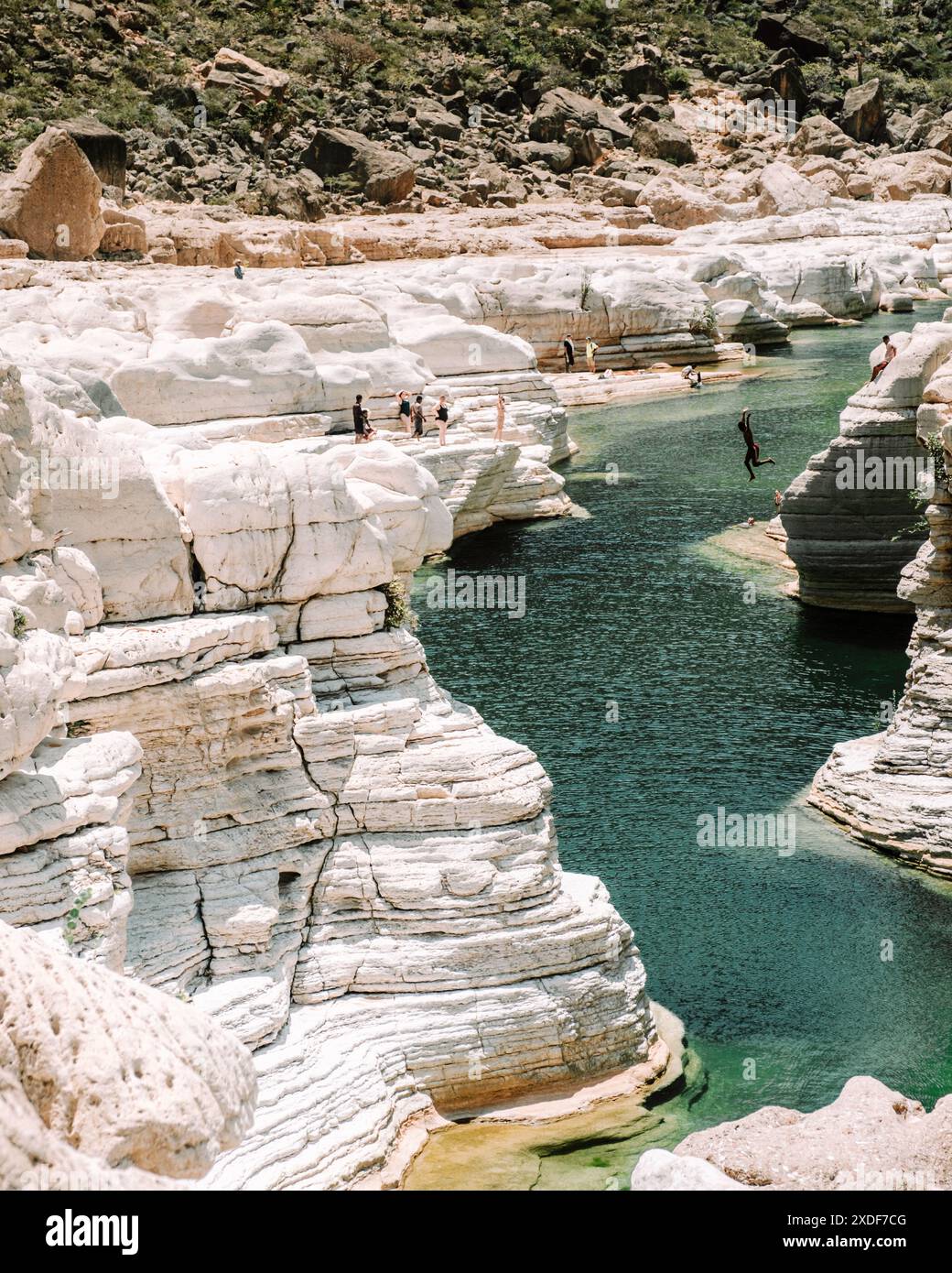 People jumping in Wadi Dirhur Canyon, Socotra Island, Yemen Stock Photo