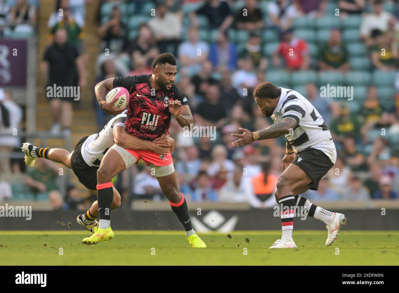 Twickenham, London, UK. 22nd June 2024. Vilimono Botituo of Fiji with the balll is tackled by Jonathan Joseph of Barbarians during the Killick Cup match between Barbarians and Fiji at Twickenham Stadium, Twickenham, United Kingdom on 22 June 2024. Photo by Phil Hutchinson. Editorial use only, license required for commercial use. No use in betting, games or a single club/league/player publications. Credit: UK Sports Pics Ltd/Alamy Live News Stock Photo