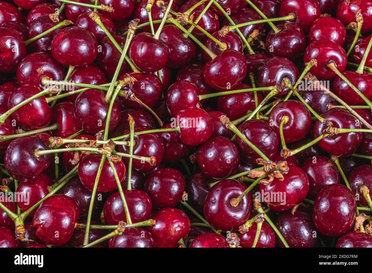 Ripe cherry in a plastic box on the table top view and side background ...