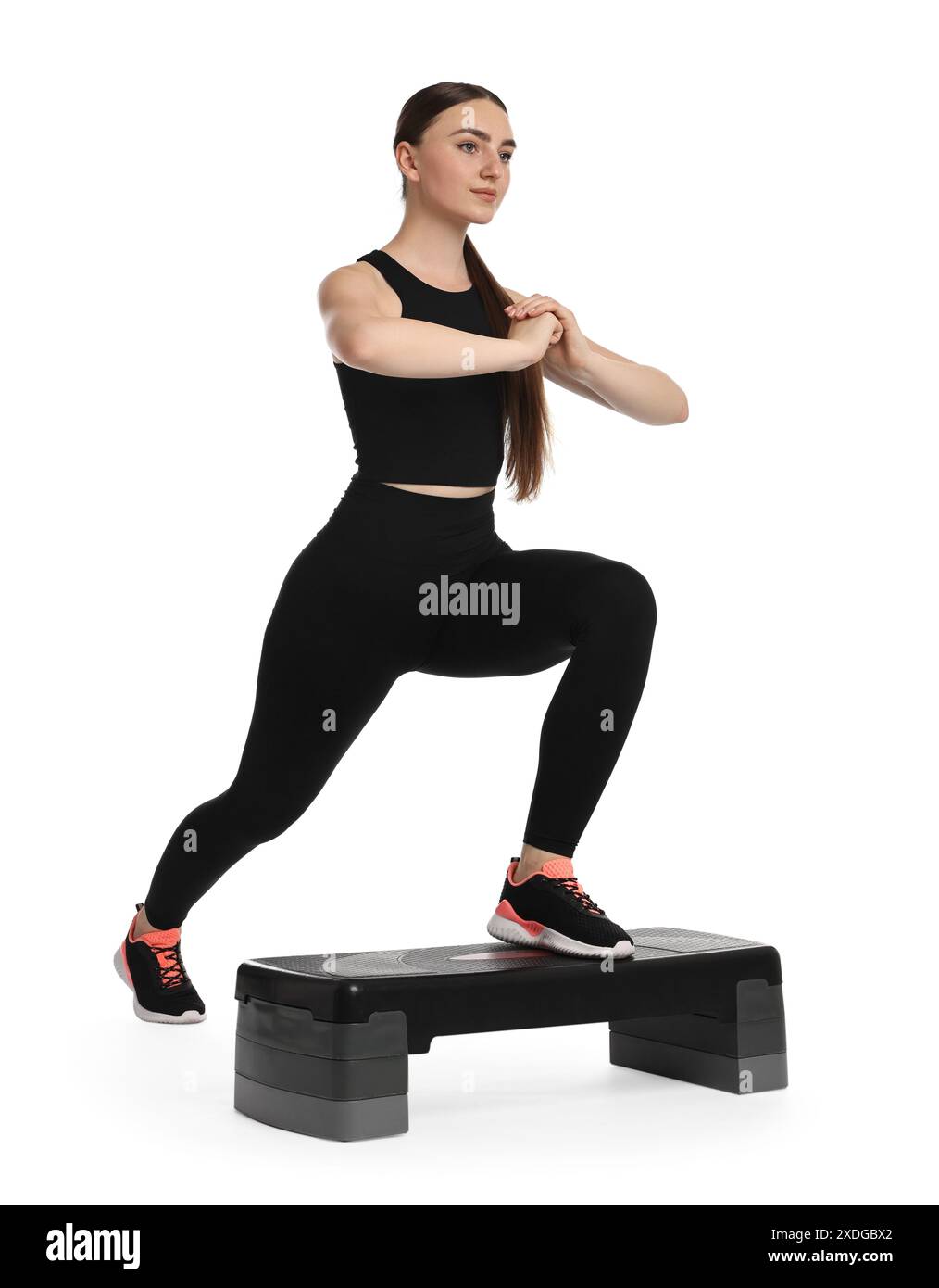 Young woman doing aerobic exercise with step platform on white ...