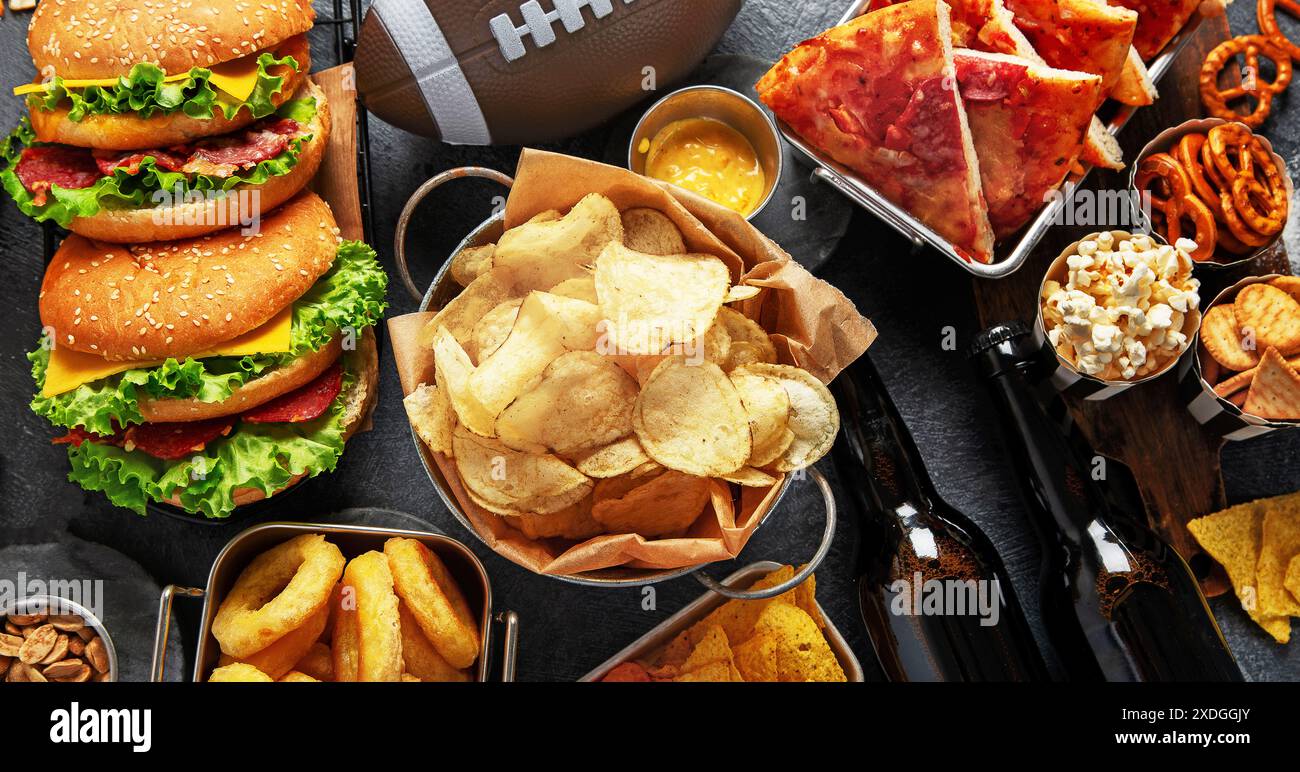 Selection of party food for watching football championship on a dark ...