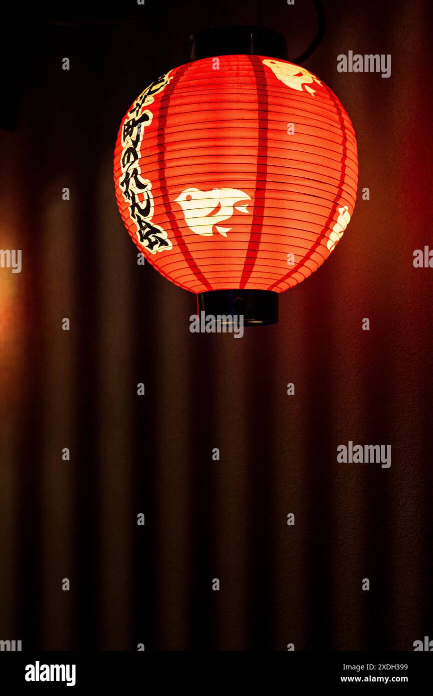 A red lighted lantern in Pontocho, a narrow lane offering atmospheric dining along Kamogawa River, in Kyoto city center, Kansai region, Japan Stock Photo