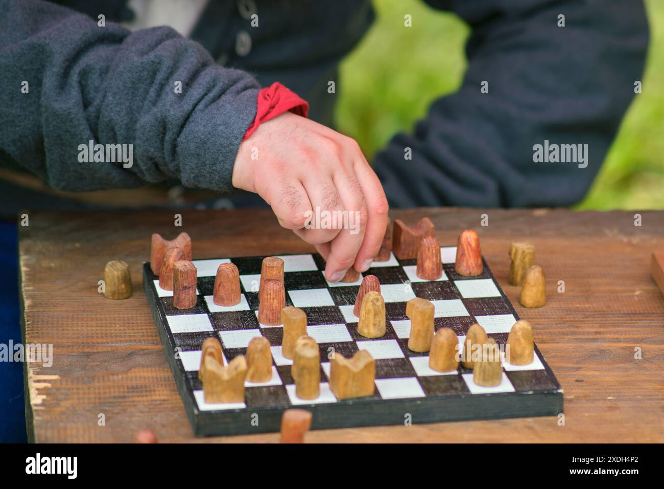 A game of vintage shatranj chess with wooden figures on a retro board A game of vintage shatranj chess with wooden figures on a retro board