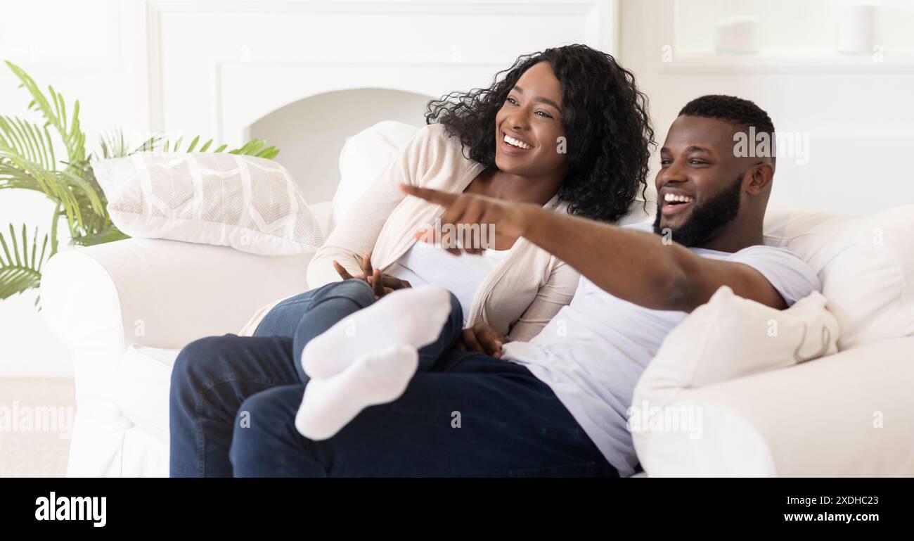 Happy Couple Relaxing On Couch Stock Photo