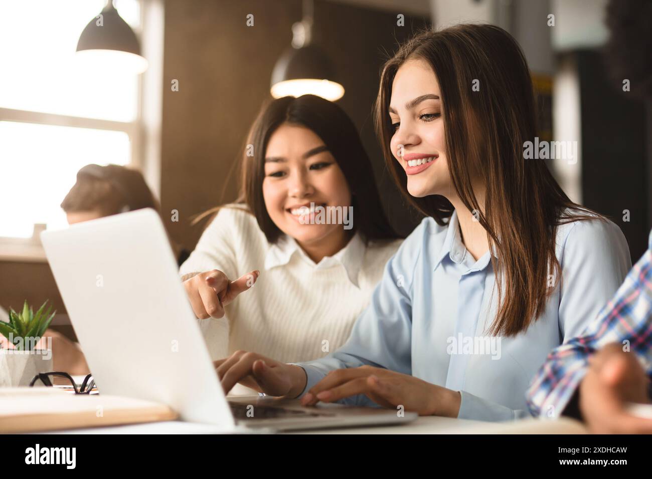 Two Women Collaborating on Project in Library Environment During Daytime Stock Photo