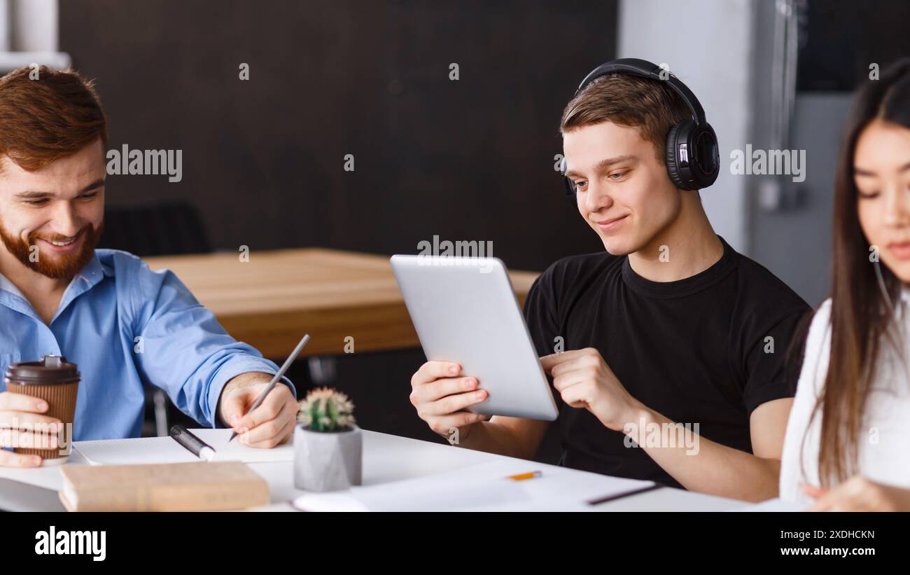 Young Adults Engaged in a Collaborative Work Session Stock Photo