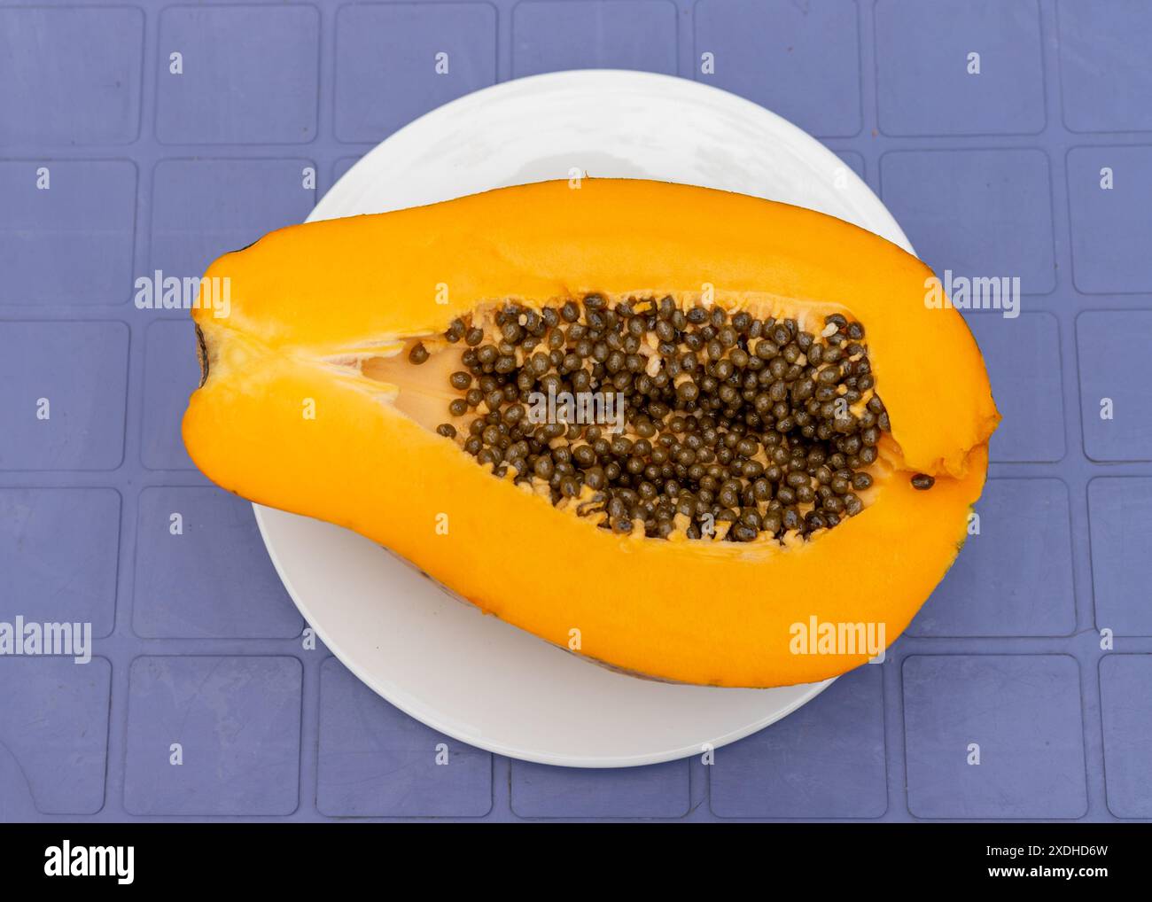 Halved Papaya Showing Seeds Inside Stock Photo