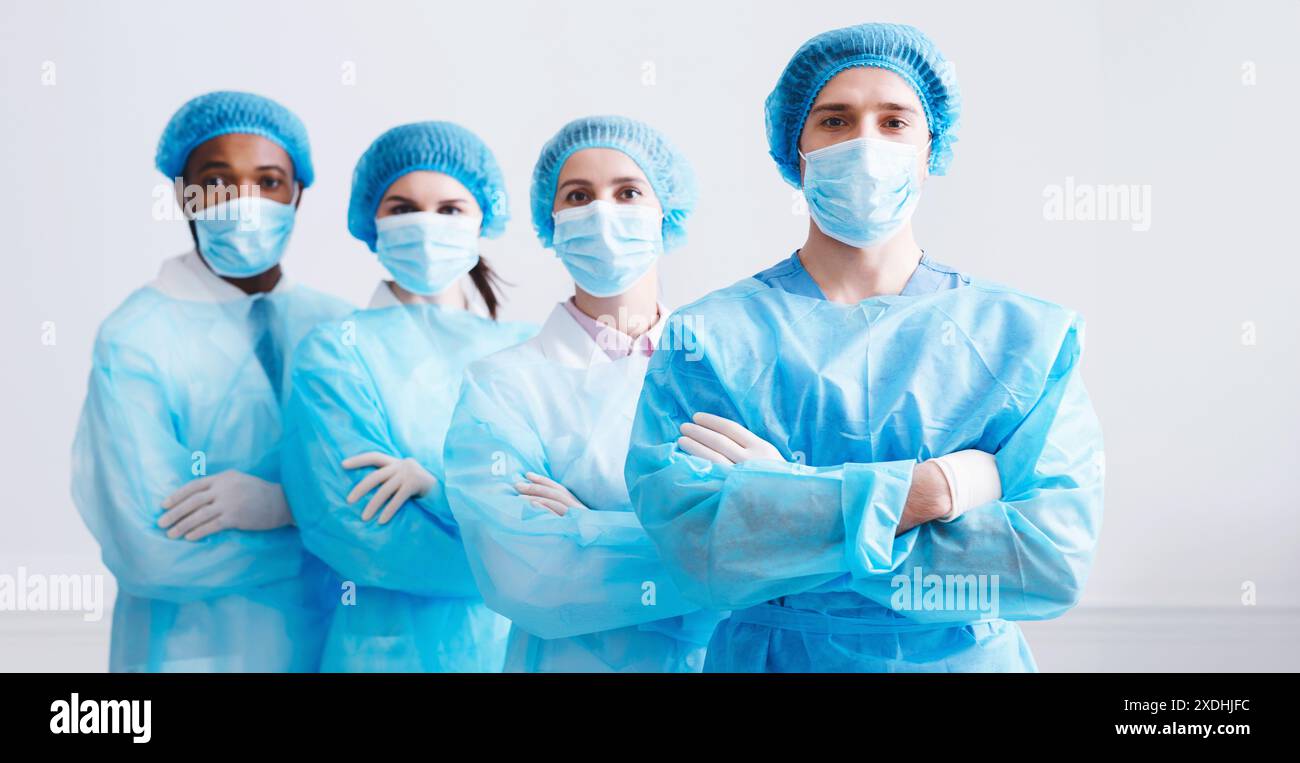 Surgeons Team Ready for Surgery. Practitioners Wearing Protective Uniforms Stock Photo