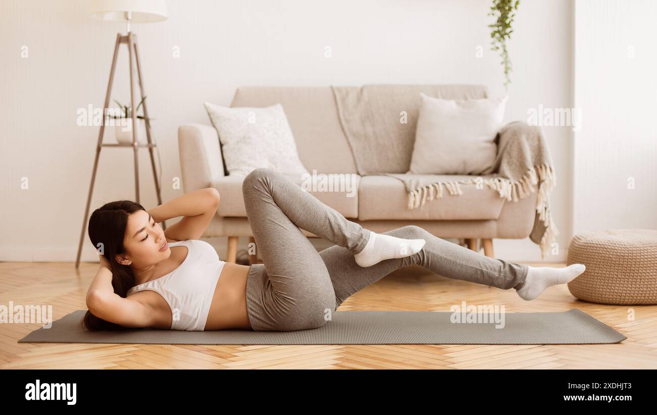 Woman Doing Ab Workout At Home Stock Photo