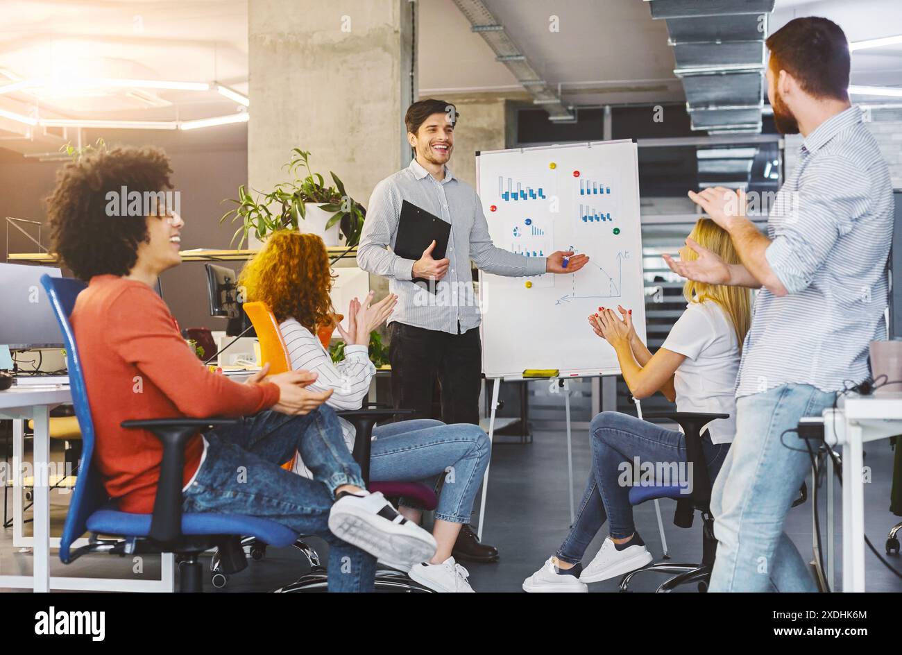 Young millennial team analyzing information on graphs and charts Stock Photo