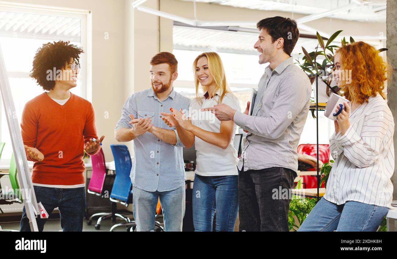 Business team appreciating colleague for explaining presentation Stock ...