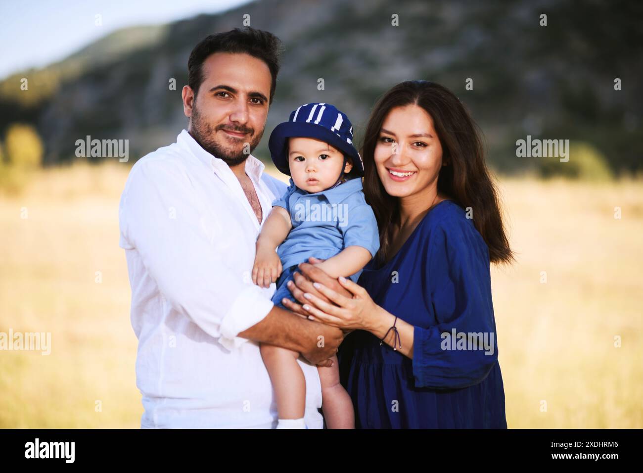 A family portrait in nature with a Turkish father, Uzbek mother, and ...