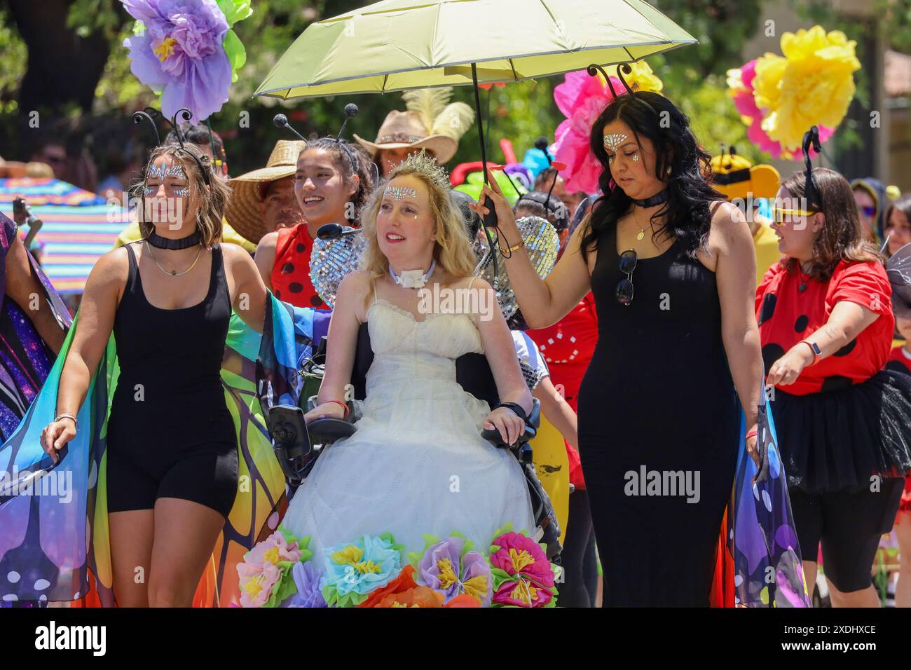 June 22, 2024, Santa Barbara, California, USA: Grace Fisher, in white dress with colorful flowers, On June 22, 2024, the 50th anniversary of the Summer Solstice Parade was held in downtown Santa Barbara. (Credit Image: © Amy Katz/ZUMA Press Wire) EDITORIAL USAGE ONLY! Not for Commercial USAGE! Stock Photo