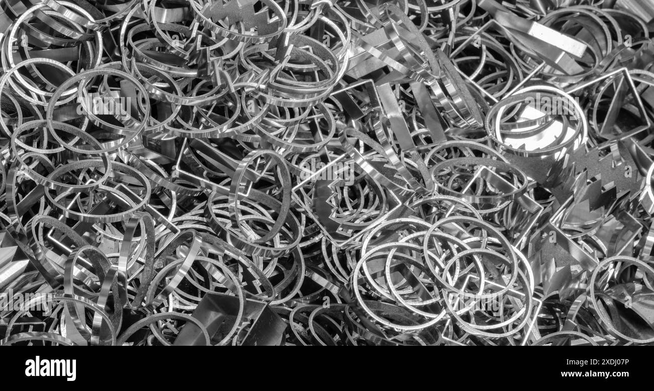 A pile of metal circles and squares. The pile is very large and is made up of many different shapes, background of metal parts Stock Photo